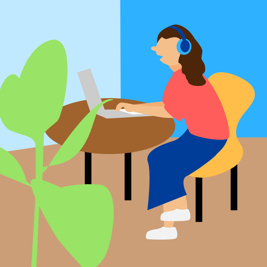 A person sitting at a desk wearing noise cancelling head phones.